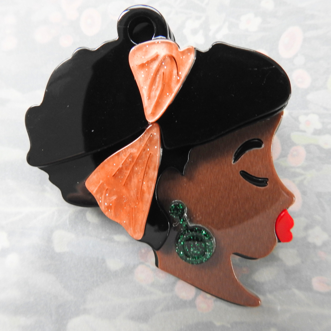 African lady's face brooch