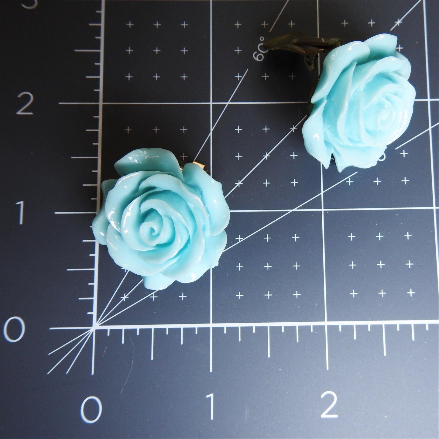 flower clip on blue earrings