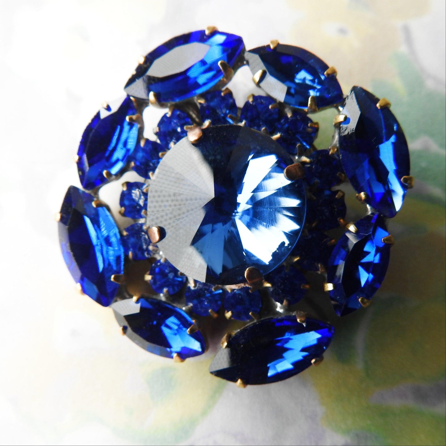 Gigantic blue crystal button made from fancy Czech glass. A nice way to add twinkle and glance to your outfit, accessory, or home decor.