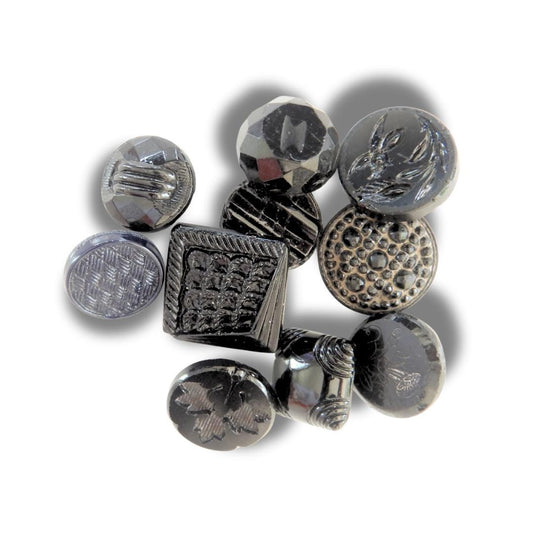 10 Czech black glass buttons from Europe. Perfect embellishments for thrifted or inherited garments—perfect for upcycling. With a shank back
