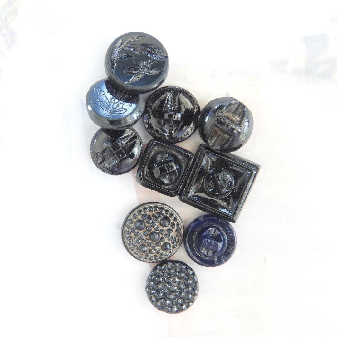 10 Czech black glass buttons from Europe. Perfect embellishments for thrifted or inherited garments—perfect for upcycling. With a shank back