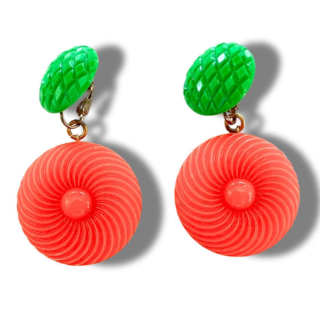 Bold and funky 1980s-inspired large neon dangle clip earrings in green and orange. Lightweight, Retro party-perfect and gift-ready