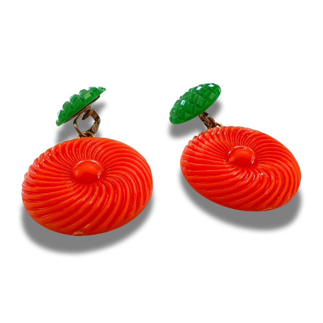 Bold and funky 1980s-inspired large neon dangle clip earrings in green and orange. Lightweight, Retro party-perfect and gift-ready