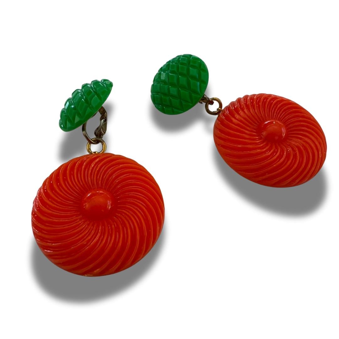 Bold and funky 1980s-inspired large neon dangle clip earrings in green and orange. Lightweight, Retro party-perfect and gift-ready