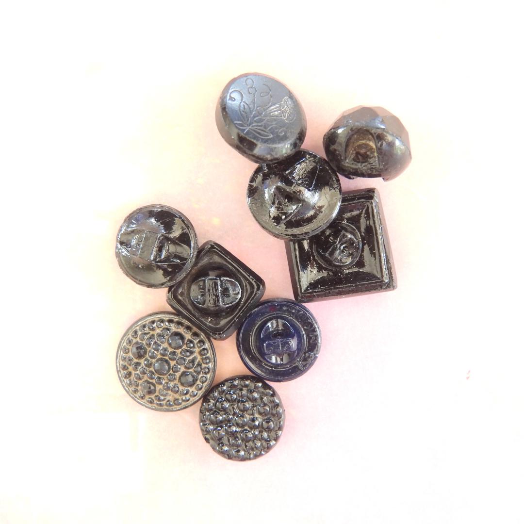 10 Czech black glass buttons from Europe. Perfect embellishments for thrifted or inherited garments—perfect for upcycling. With a shank back