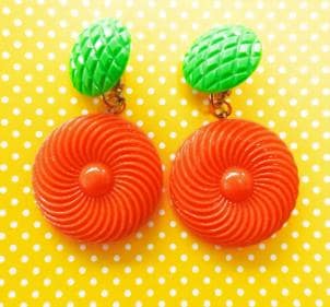 Bold and funky 1980s-inspired large neon dangle clip earrings in green and orange. Lightweight, Retro party-perfect and gift-ready