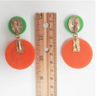 Bold and funky 1980s-inspired large neon dangle clip earrings in green and orange. Lightweight, Retro party-perfect and gift-ready