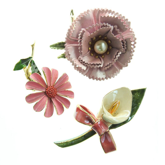 Vintage enamel flower brooches collection, set of 3. Pink blush, green, and white with one rose, one daisy, one lily. Era 1960s, mod style.