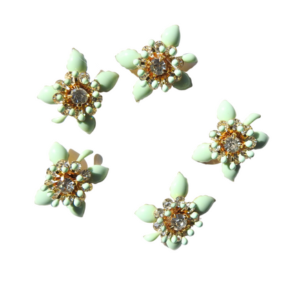 Mint-green flower-shaped decorative buttons.