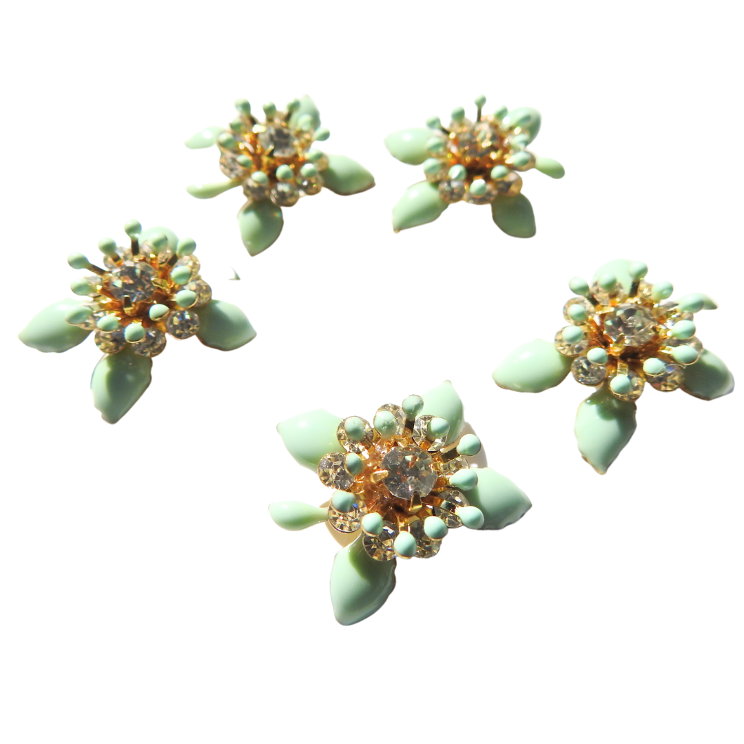 Mint-green flower-shaped decorative buttons.