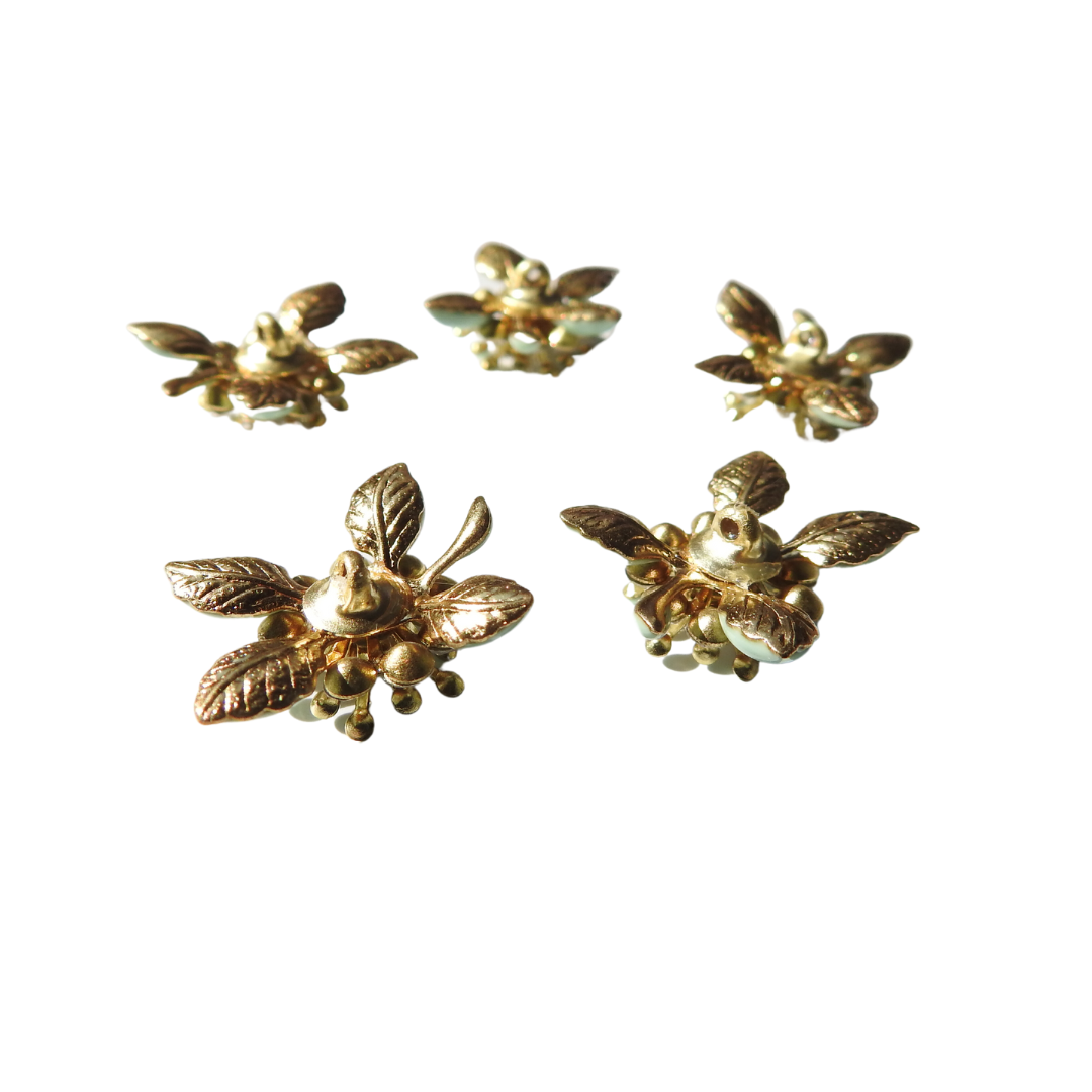 Mint-green flower-shaped decorative buttons.