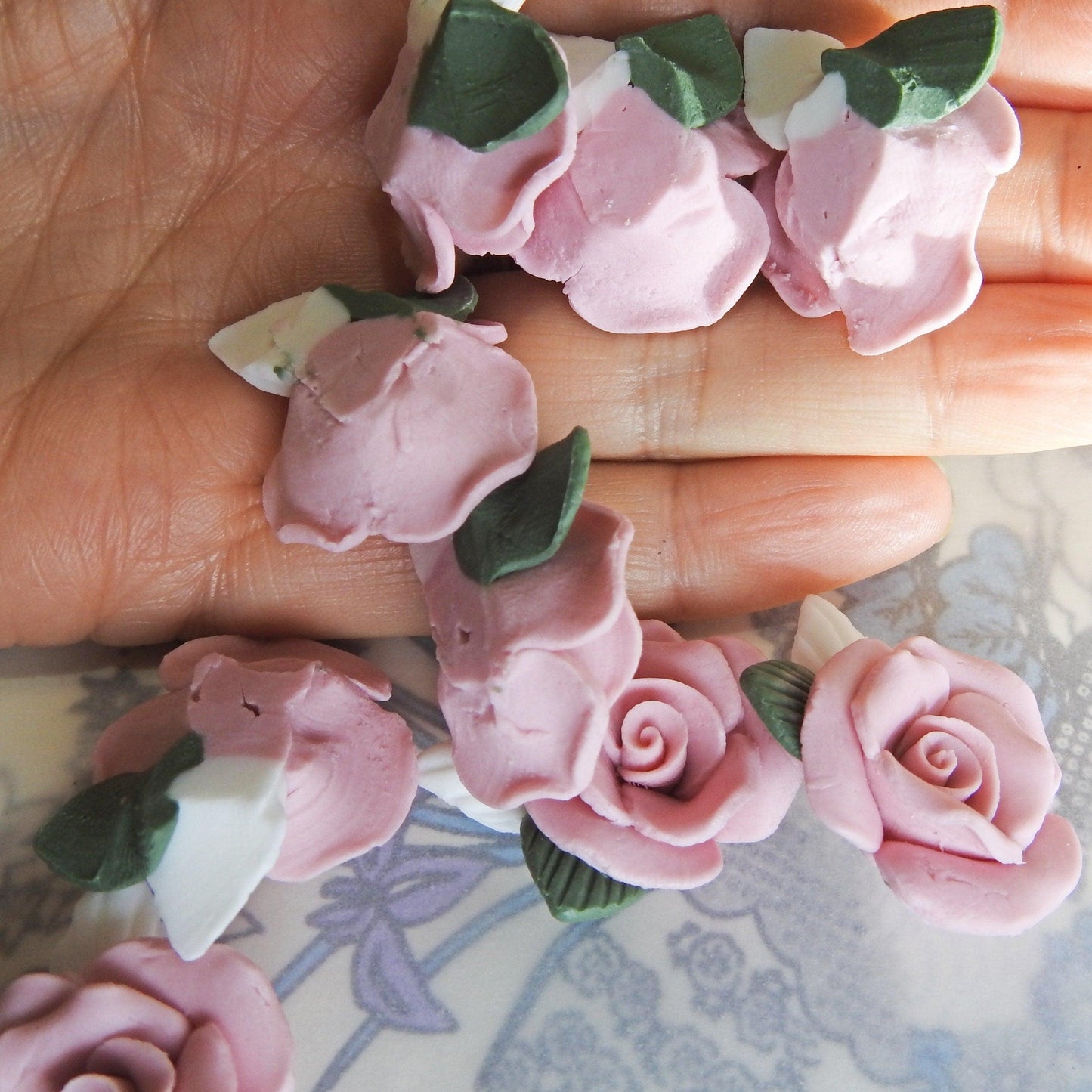 Dusty pink flower cabochons, made from matte bisque ceramic clay with white and green leaves for gluing on DIY jewelry. Lot of 10, 23-25m