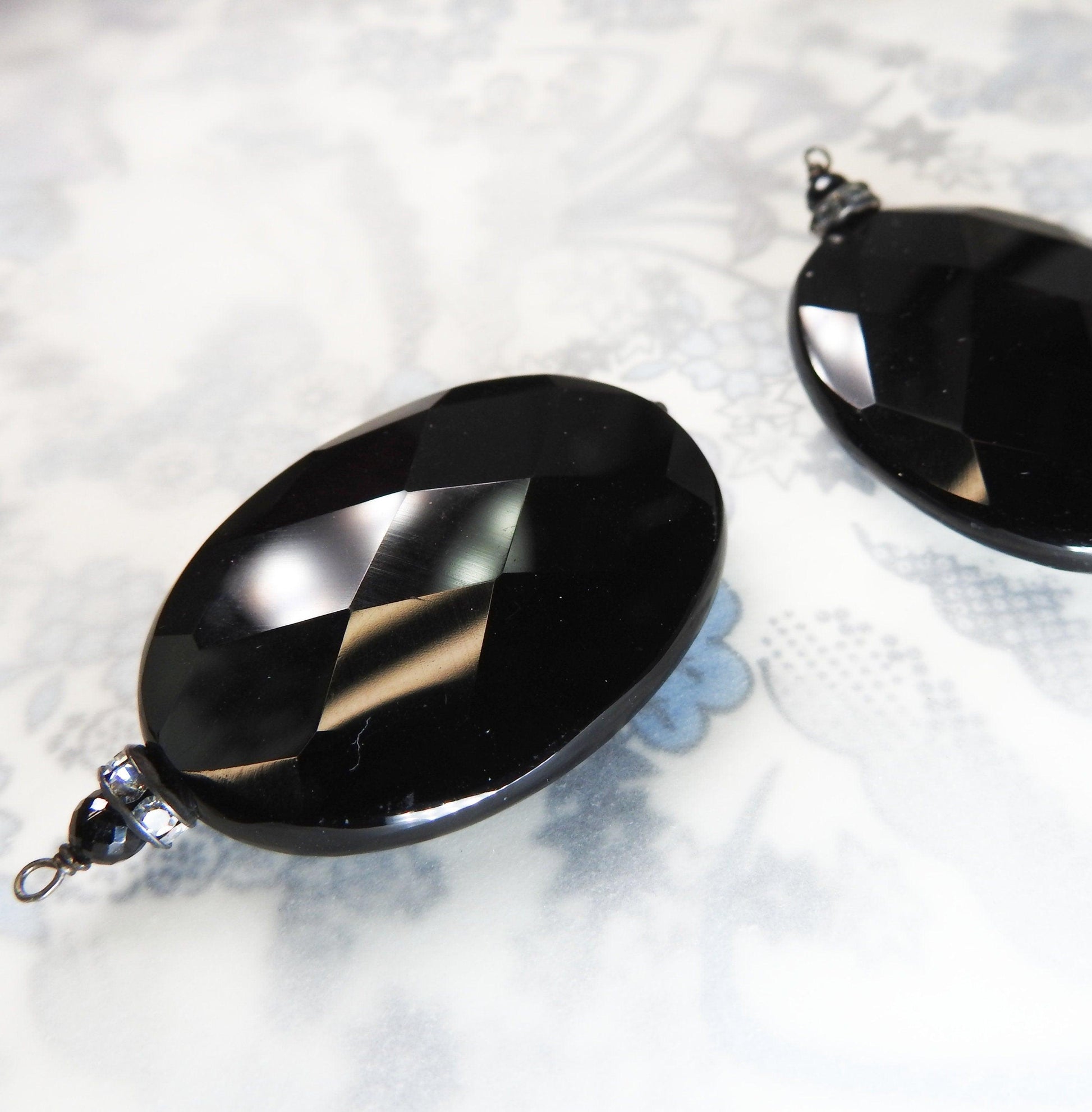 Faceted glass pendants components for making earrings. Jet black chandelier or vintage pendulous oval shaped focal teardrop adornment