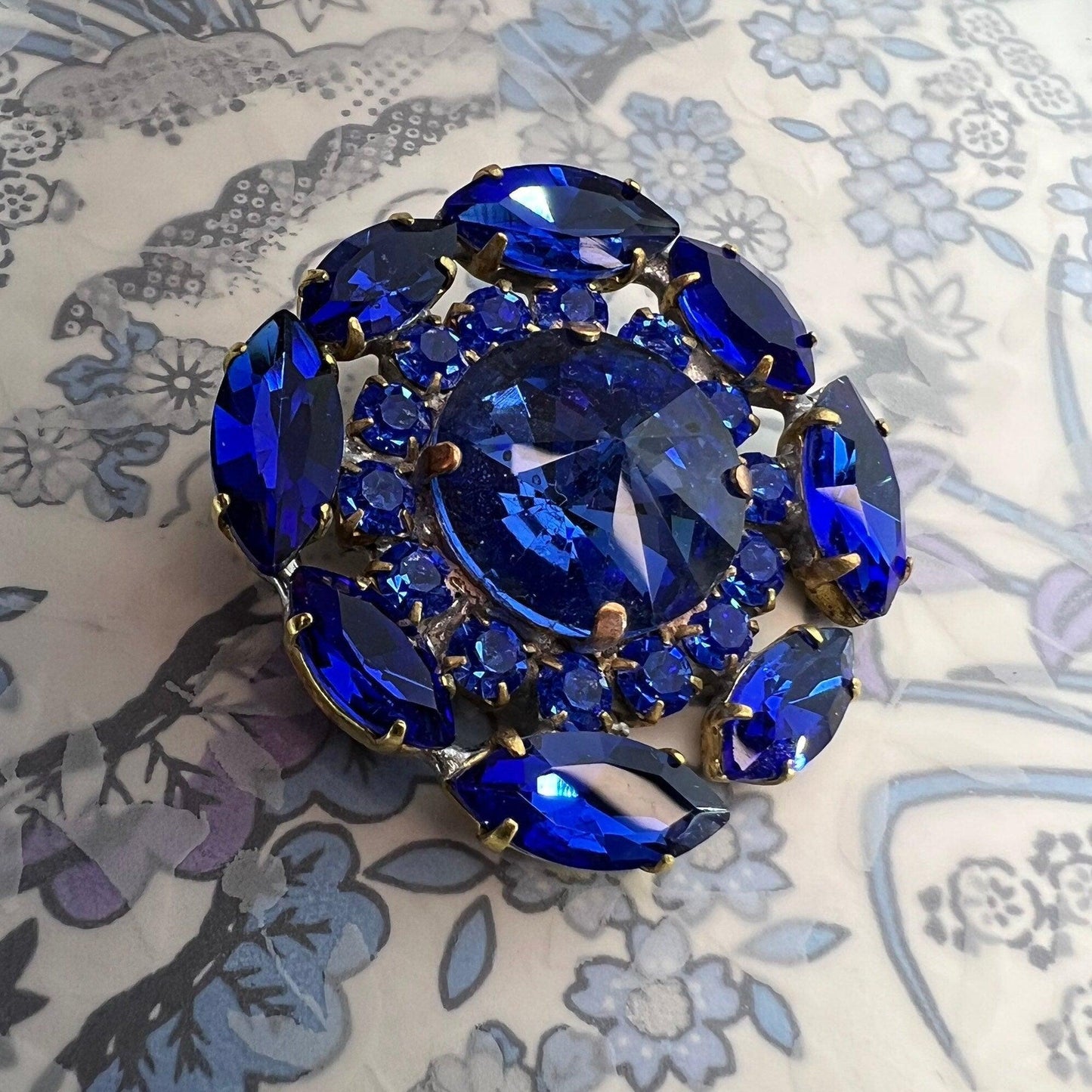 Gigantic blue crystal button made from fancy Czech glass. A nice way to add twinkle and glance to your outfit, accessory, or home decor.