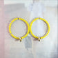 Honey bee earrings hoop for women, handmade in Canada with a cute bug charm and eye-catching yellow glass beads. Diameter about 45 mm, 2 in.