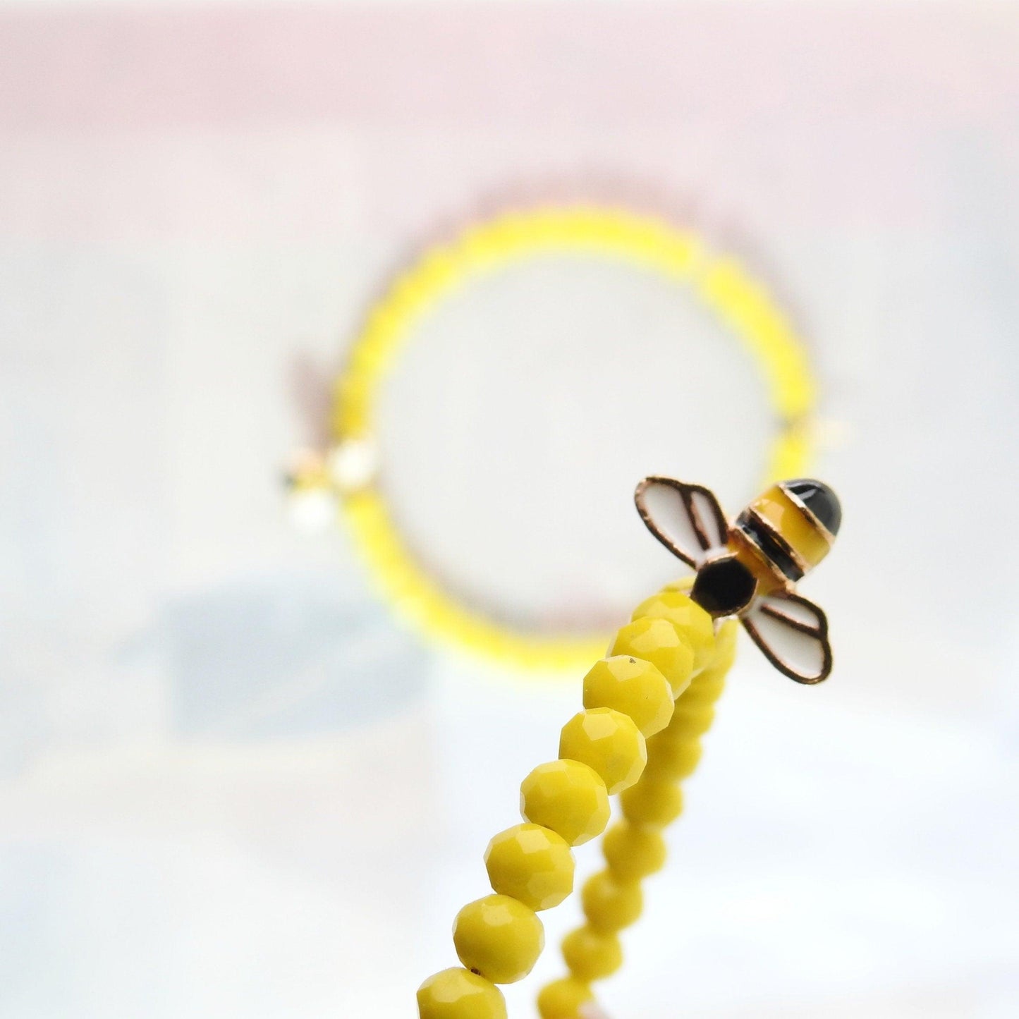 Honey bee earrings hoop for women, handmade in Canada with a cute bug charm and eye-catching yellow glass beads. Diameter about 45 mm, 2 in.