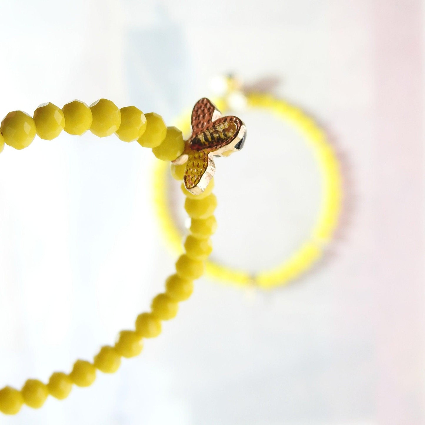 Honey bee earrings hoop for women, handmade in Canada with a cute bug charm and eye-catching yellow glass beads. Diameter about 45 mm, 2 in.