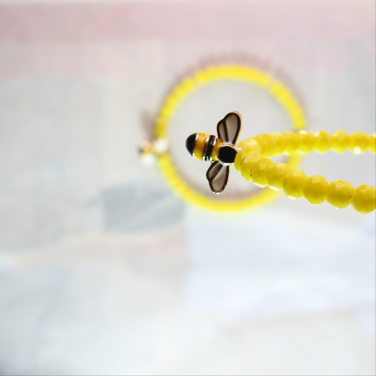 Honey bee earrings hoop for women, handmade in Canada with a cute bug charm and eye-catching yellow glass beads. Diameter about 45 mm, 2 in.