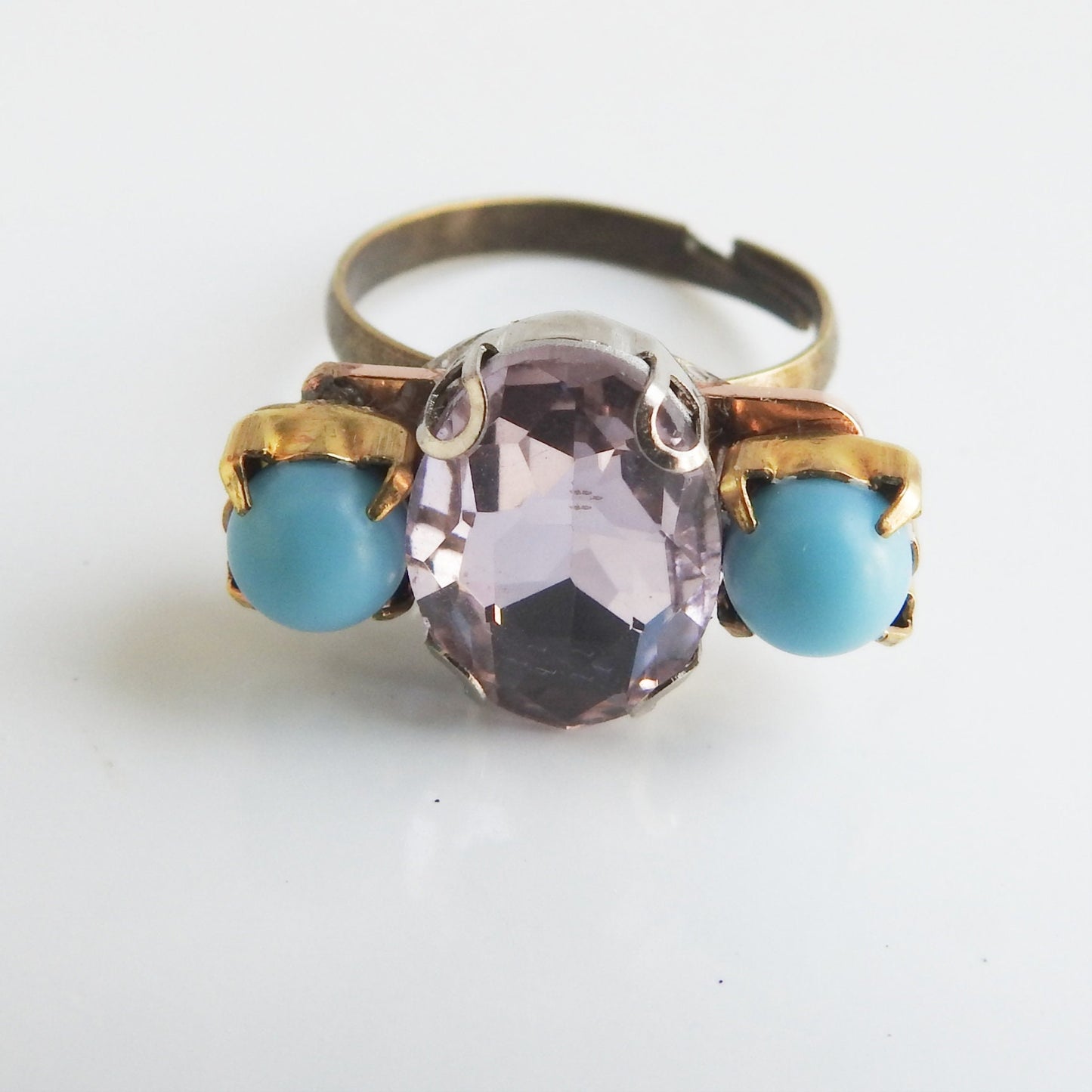 Light pink ring with blue stones