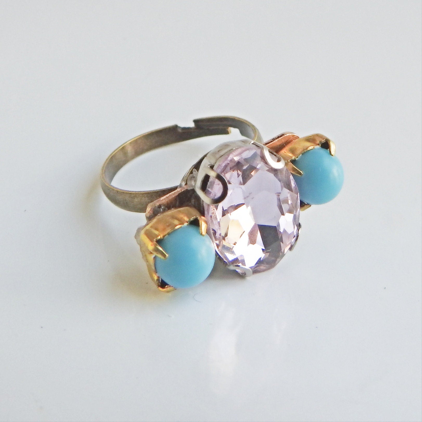 Light pink ring with blue stones