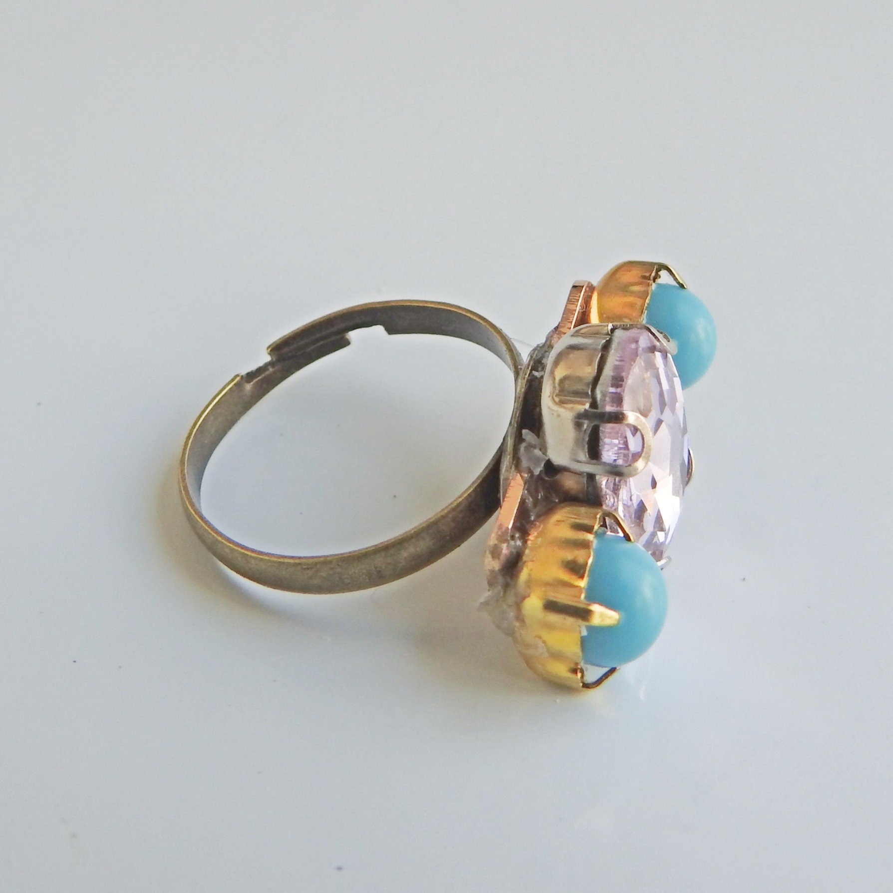 Light pink ring with blue stones