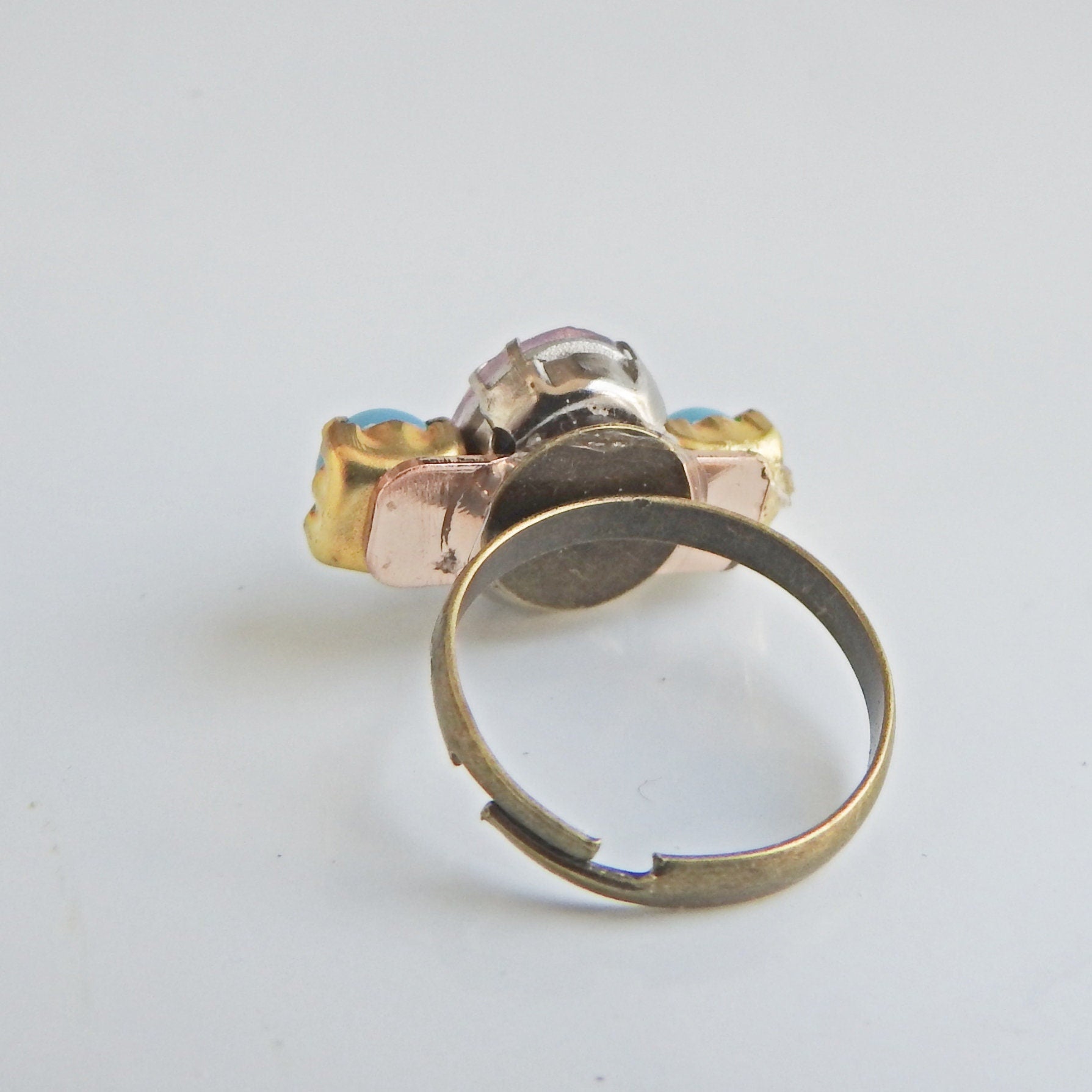 Light pink ring with blue stones