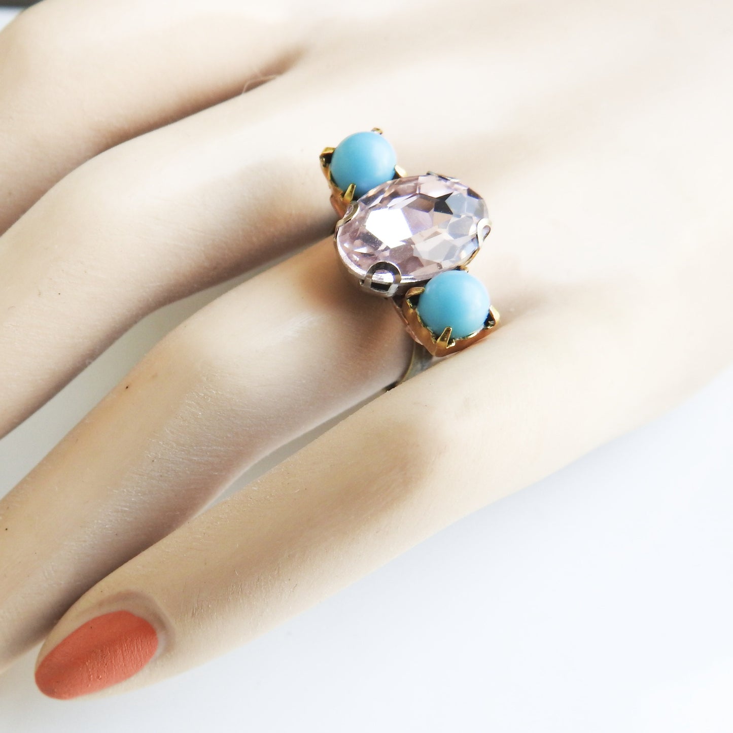 Light pink ring with blue stones