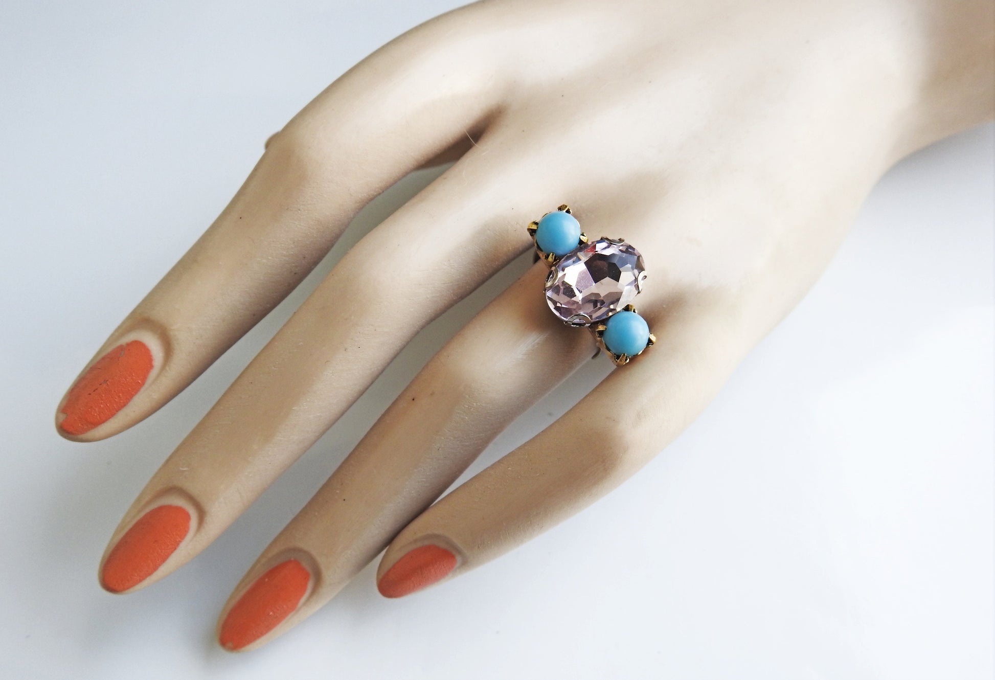 Light pink ring with blue stones