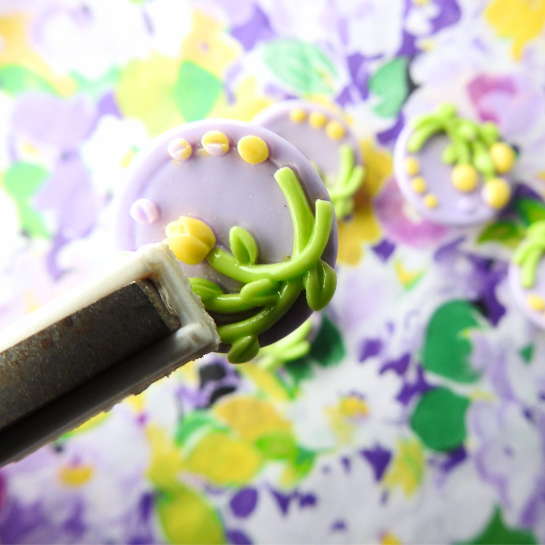 Purple buttons with yellow tulips flowers