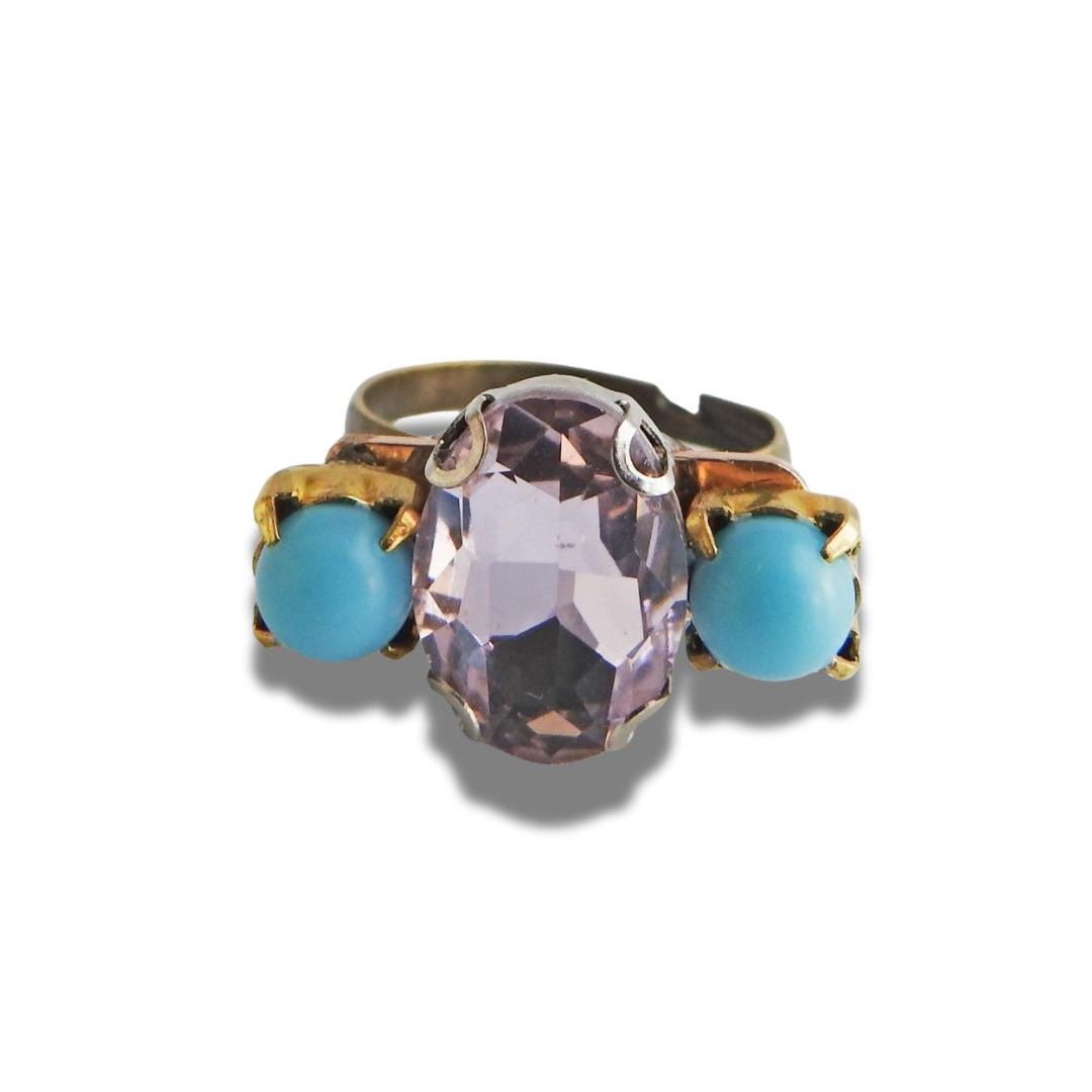 Light pink ring with blue stones