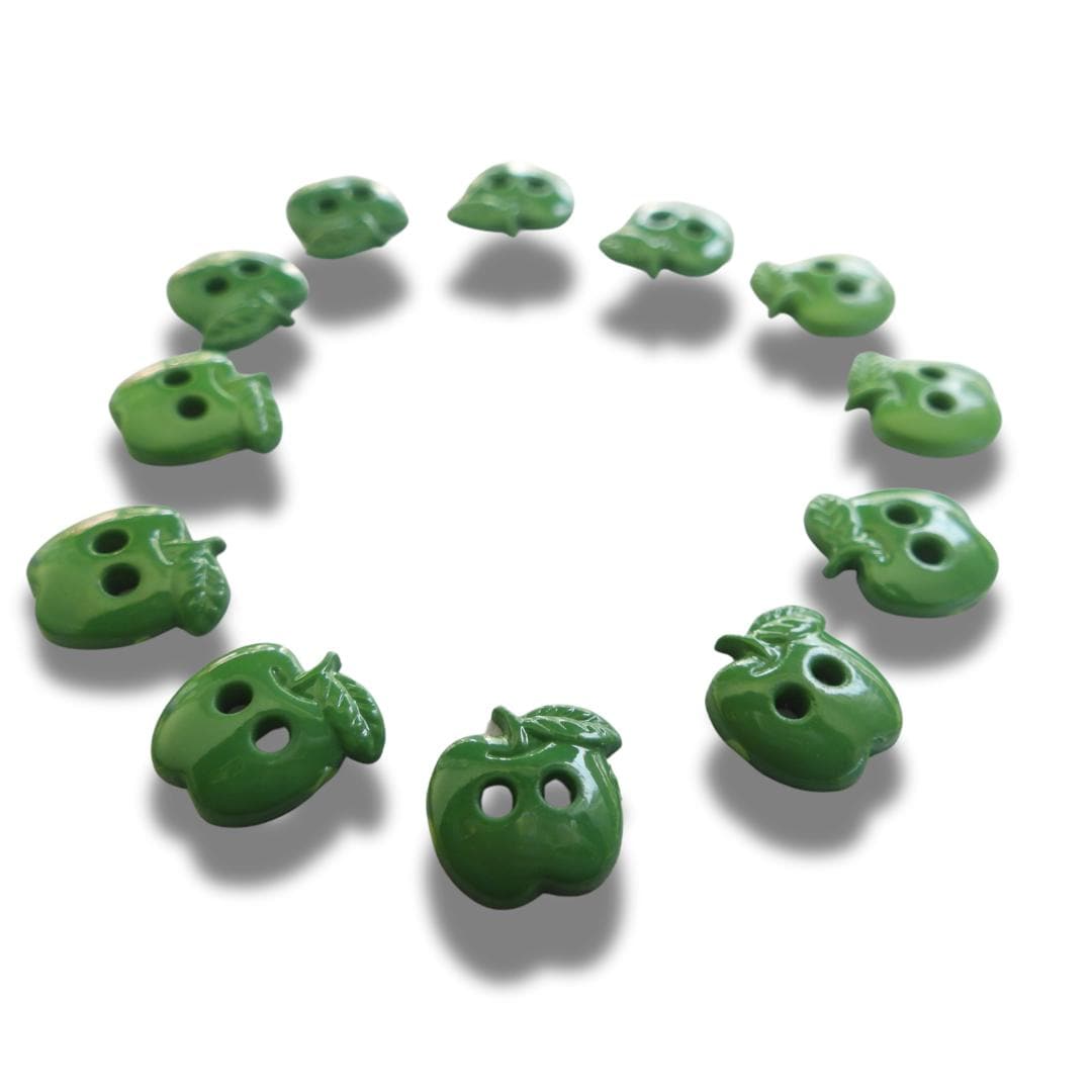 Set of 12 green apple-shaped buttons for sewing and crafting. 2-hole design, perfect for fun DIY projects, clothing, and accessories.