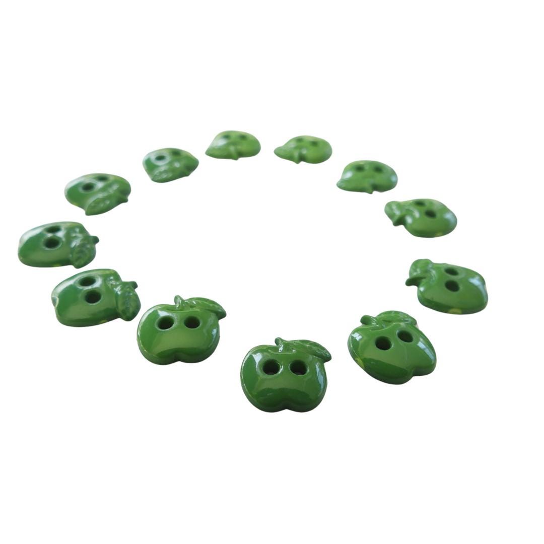 Set of 12 green apple-shaped buttons for sewing and crafting. 2-hole design, perfect for fun DIY projects, clothing, and accessories.