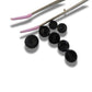 Set of 7 antique Victorian black glass buttons for sewing - 2-hole, 8–15 mm, Czech molded glass. Glossy floral & geometric patterns