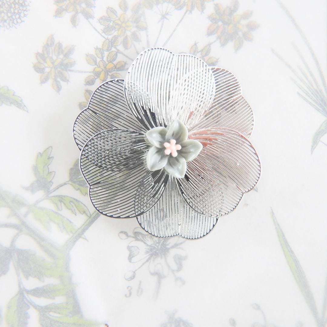 Oversized 40 mm flower button with silver petals, grey and pink floral center, shank back. Lightweight and perfect for sewing or crafts