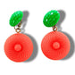 Bold and funky 1980s-inspired large neon dangle clip earrings in green and orange. Lightweight, Retro party-perfect and gift-ready