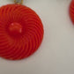 Bold and funky 1980s-inspired large neon dangle clip earrings in green and orange. Lightweight