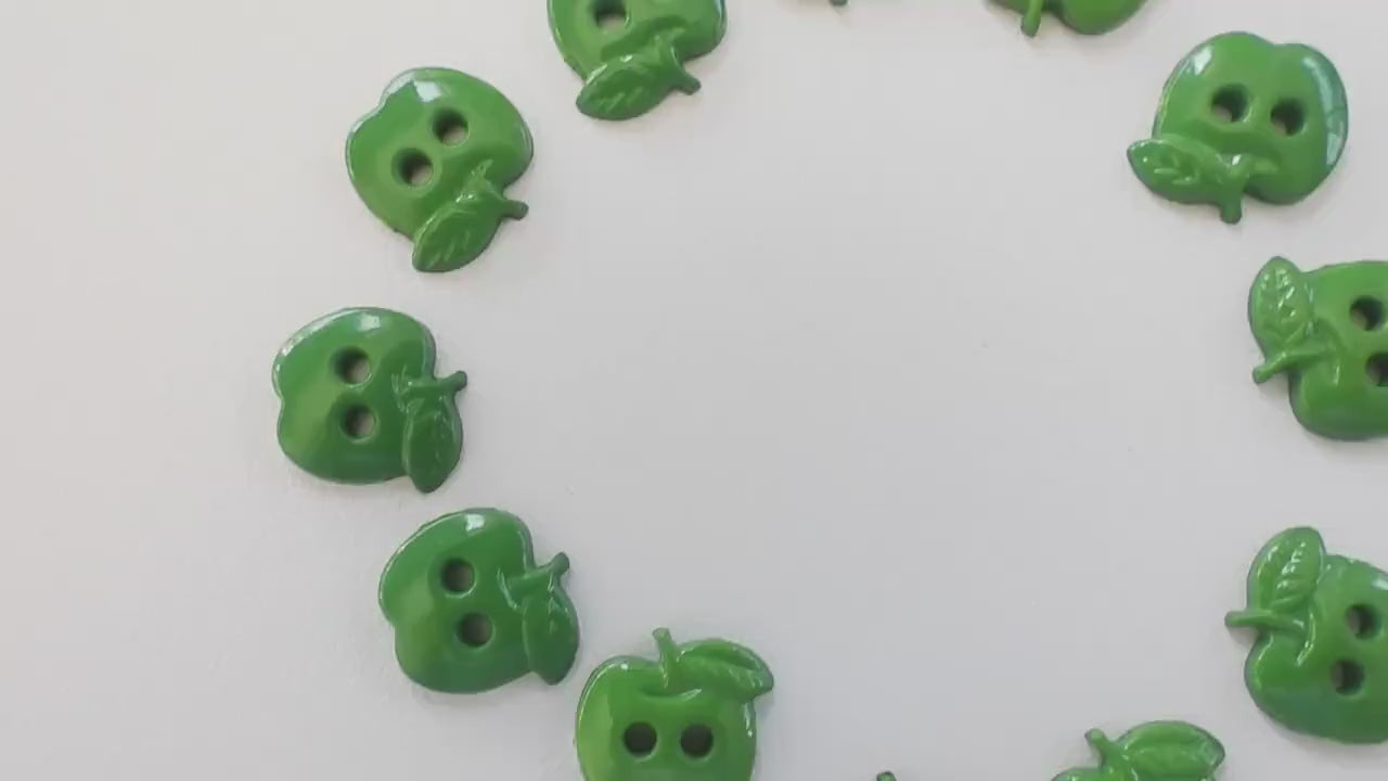 Set of 12 green apple-shaped buttons for sewing and crafting. 2-hole design
