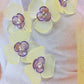 Flower-shaped buttons for clothes. Purple and yellow