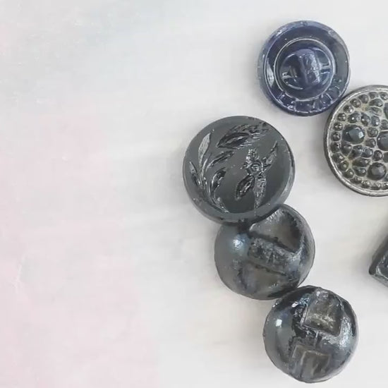 10 Czech black glass buttons from Europe. Perfect embellishments for thrifted or inherited garments—perfect for upcycling. With a shank back