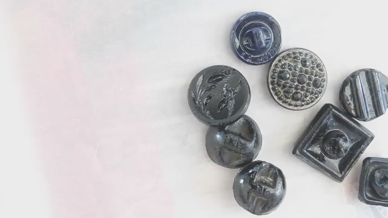 10 Czech black glass buttons from Europe. Perfect embellishments for thrifted or inherited garments—perfect for upcycling. With a shank back