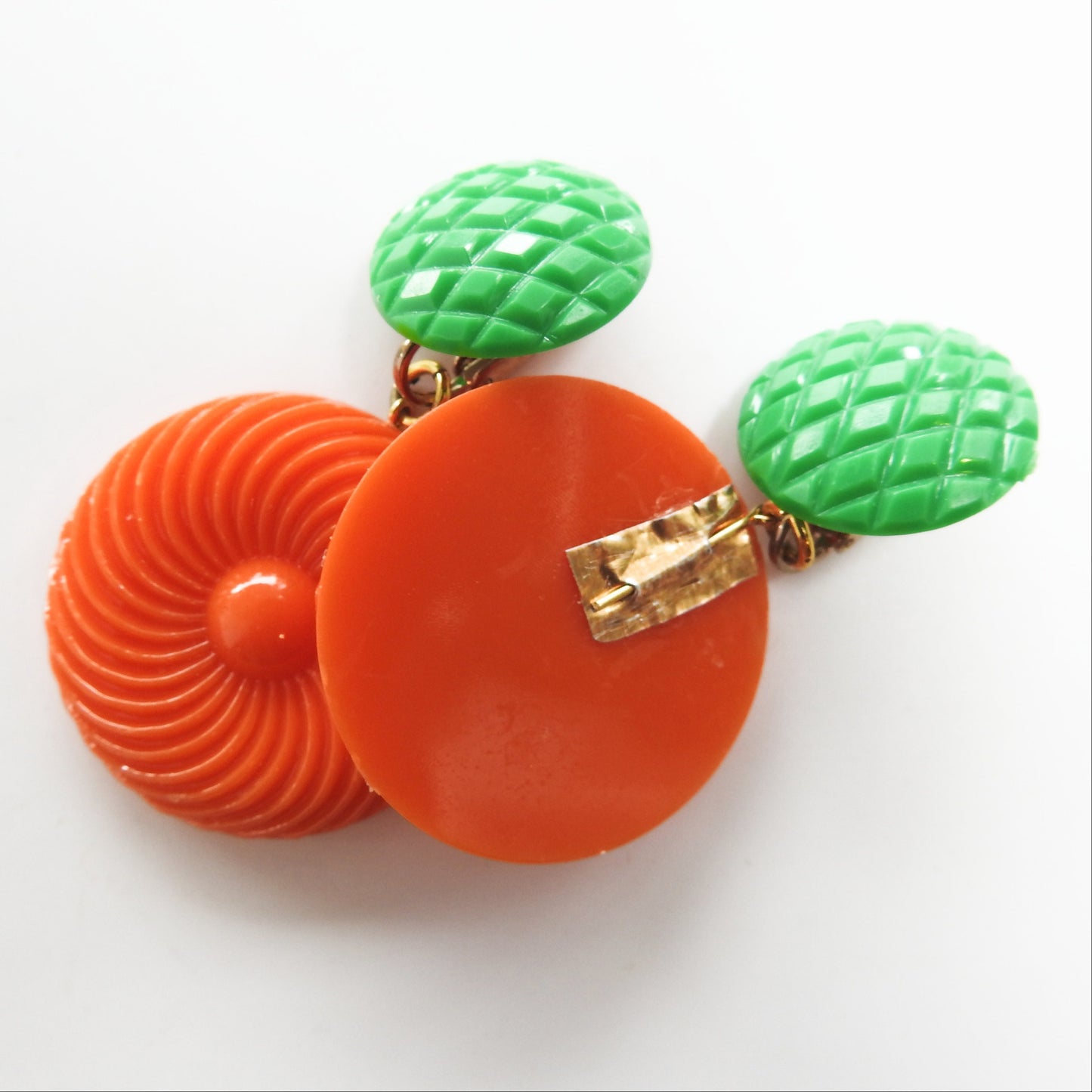 Neon orange dangle clip earrings for women. Cool jewelry gift ideas under 25 dollars. 1970s 1980s-inspired funky style. Ready to ship