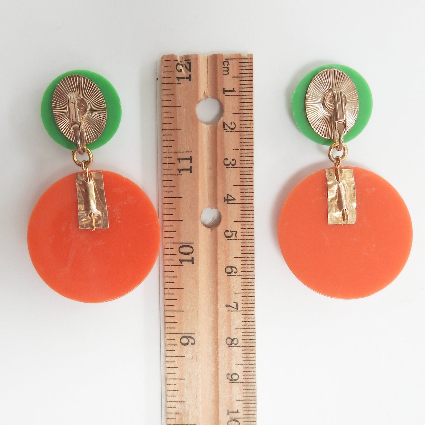 Neon orange dangle clip earrings for women. Cool jewelry gift ideas under 25 dollars. 1970s 1980s-inspired funky style. Ready to ship