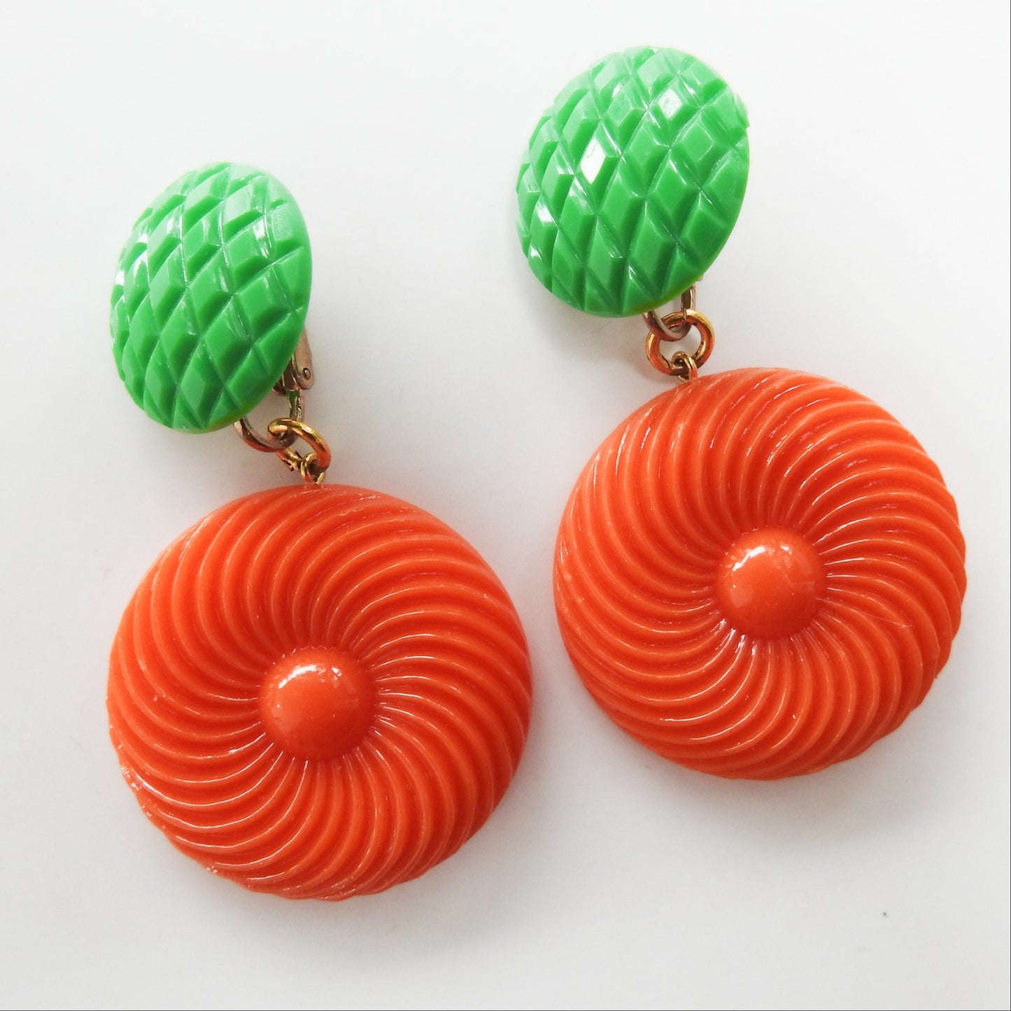 Neon orange dangle clip earrings for women. Cool jewelry gift ideas under 25 dollars. 1970s 1980s-inspired funky style. Ready to ship