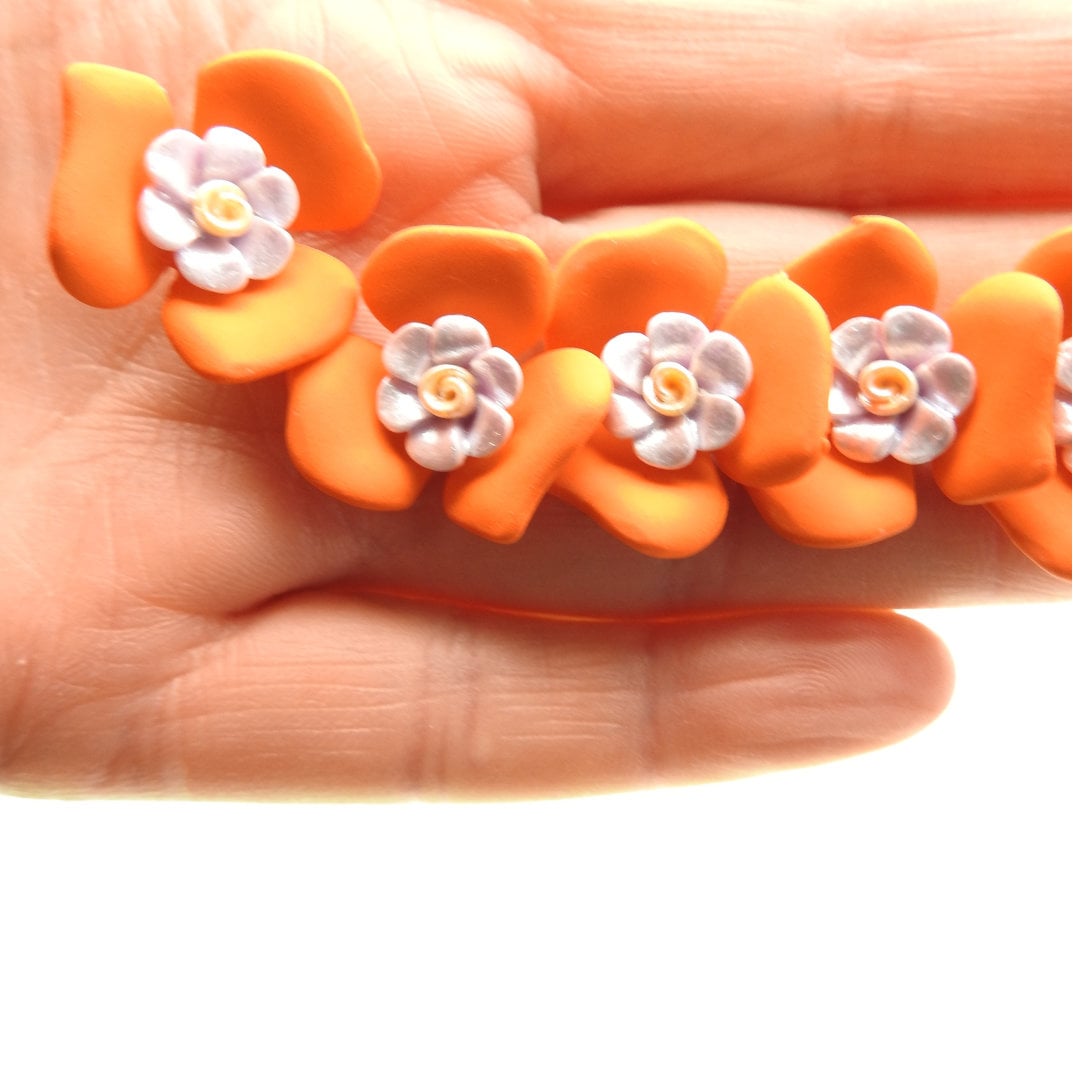 Set of 5 fun flower-shaped fashion buttons, orange and purple. Good for sewing on fabric, jewelry, hats, belts, collars, and corsages. 23 mm